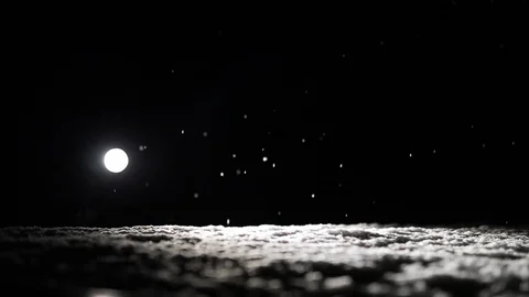 Snow flakes in the black sky fall from above Video stock 126350190