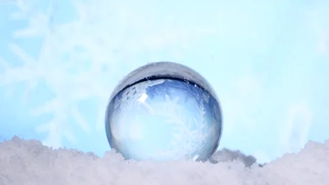 Snow flakes falling on a crystal globe Stockbeeldmateriaal 208090459