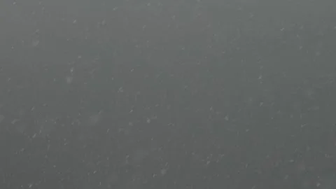 Snow flakes falling over grey background 库存影片 289777098