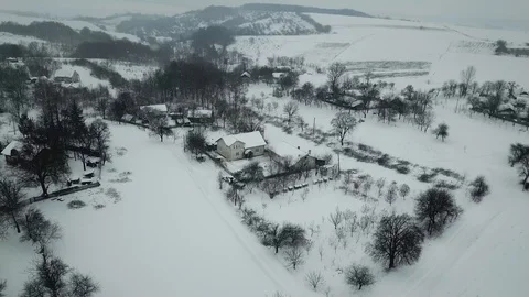Snow flies directly into the camera.Winter. View of a small village Stock Footage 114651694