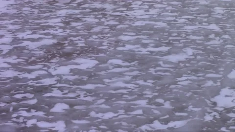 Snow Flurries Over Rippled Sheet of Ice Stock Footage 233298406