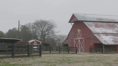 Snow Flutters at a Red Barn in Winter Stock Footage 297135554