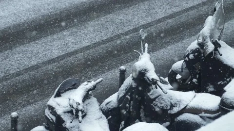 Snow gently falling on motorcycles in Paris, France Stock Footage 138698092