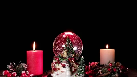 Snow glob and two rustic candles at Christmas Stock Footage 165603601