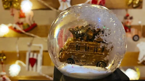 Snow globe on background of christmas tree with christmas lights. Wooden Stock Footage 145531613