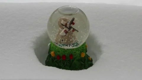 Snow globe stands in a snowdrift Stock Footage 148328394