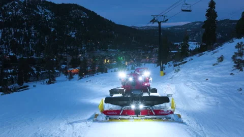 Snow groomer working on ski slope at night aerial Close Up Aerial Drone Snow Stock Footage 338369367