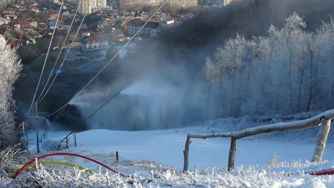 Snow gun making artificial snow in morning, on back fir forest. Stock Footage 167789049