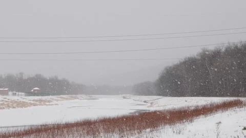 Snow hand held real time video, snow storm, extreme weather, winter frozen river Stock Footage 262379220