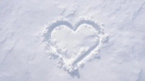 Snow heart. Romantic winter pattern. Heart symbol in snow. Snowy heart banner Stock Photos