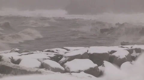 Snow ice massive waves crashing ashore in winter storm Stock Footage 46525108