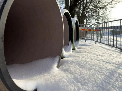 Snow inside large pre insulated pipeline at urban infrastructure site Stock Photos