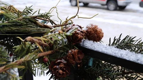 Snow lightly falls on pine cone garland Stock Footage 123988115