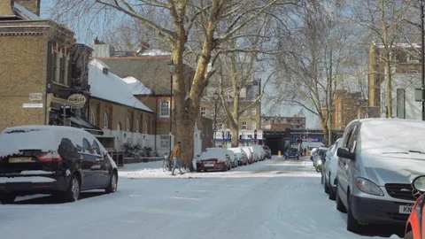 Snow on London residential street Stock Footage