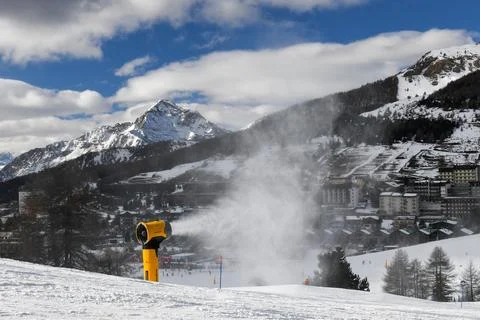 Snow machine making powder snow in European ski resort Stock Photos