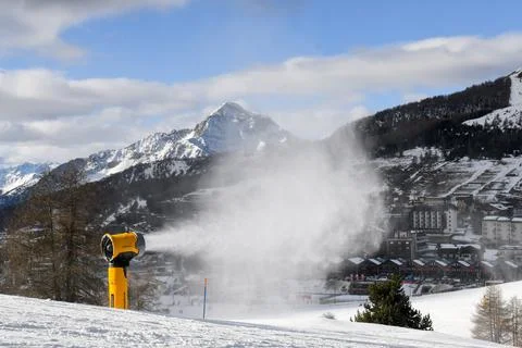 Snow machine making powder snow in European ski resort Stock Photos