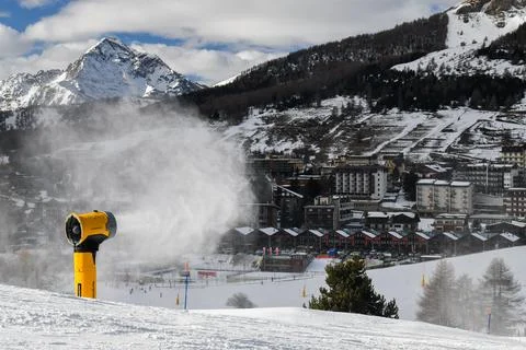Snow machine making powder snow in European ski resort Stock Photos