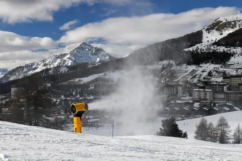 Snow machine making powder snow in European ski resort Stock Photos
