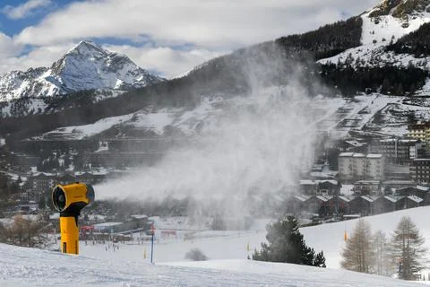 Snow machine making powder snow in European ski resort Stock Photos