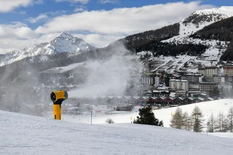 Snow machine making powder snow in European ski resort Stock Photos