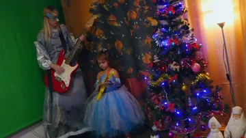 Snow maiden and snowflake with guitars dancing near the Christmas tree Stock Footage