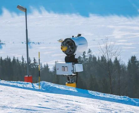 Snow making machine at a ski resort on a sunny winters day. 스톡 사진