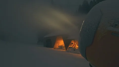 Snow making machine on ski slope at night Stock Footage 100416960