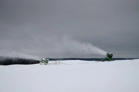 Snow making machine on the ski slope in winter. Spraying snow powder. Stock Photos