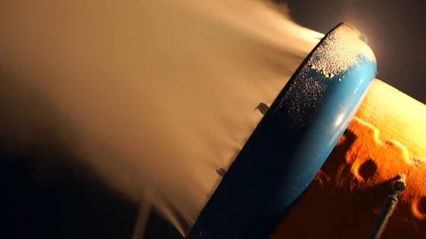 Snow making system. A snow cannon sprays water and makes snow. At night, the Stock Footage 124277520