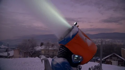 Snow making system. A snow cannon sprays water and makes snow. At night, the Stock Footage 124277528
