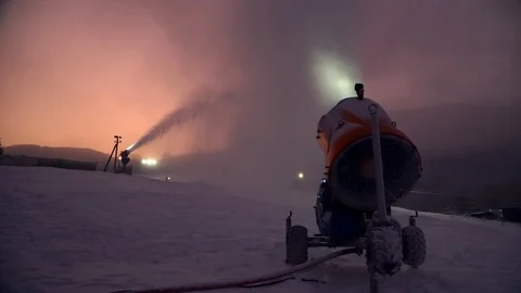 Snow making system. A snow cannon sprays water and makes snow. On sunrise, the Stock Footage 124277564