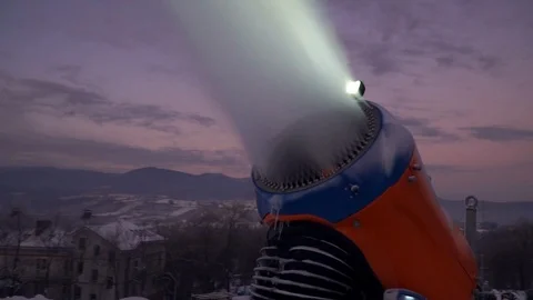Snow making system. A snow cannon sprays water and makes snow. On sunrise, the Stock Footage 124277583