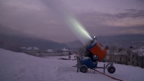 Snow making system. A snow cannon sprays water and makes snow. At night, the Stock Footage 124277598