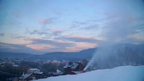 Snow making system. A snow cannon sprays water and makes snow. At night, the Stock Footage 124277607