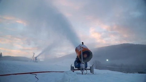 Snow making system. A snow cannon sprays water and makes snow. At night, the Stock Footage 124277615