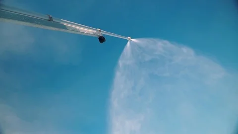 Snow making system. A snow cannon sprays water and makes snow. At night, the Stock Footage 124277631