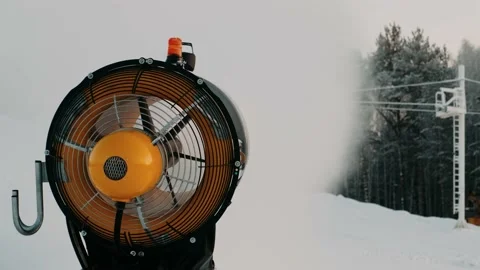 Snow making system. A snow cannon sprays water and makes snow. Video stock 144338660