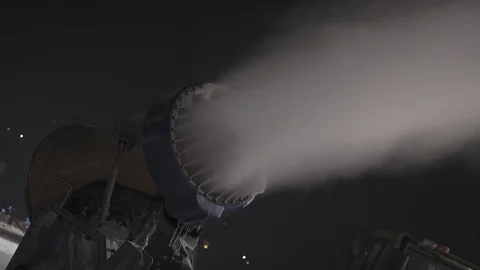 Snow making system in work at night. Snow cannon Stock Footage 97798619