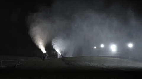 Snow making system in work. Several snow machines produce snow at night. Stock Footage 97283844