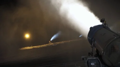 Snow making system in work. Several snow machines produce snow at night. Stock Footage 97795774