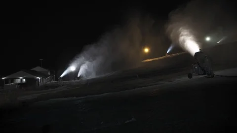 Snow making system in work. Several snow machines produce snow at night. Stock Footage 97795846