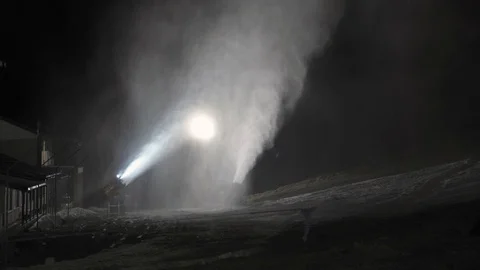 Snow making system in work. Several snow machines produce snow at night. 動画素材 97795864