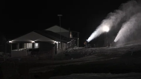 Snow making system in work. Several snow machines produce snow at night. Stock Footage 97796029