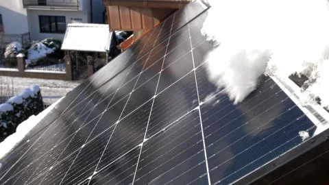 Snow Melting on PV Solar Panels Located on Private House Roof on Sunny Day Stock Footage 259182807