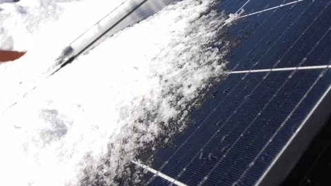 Snow Melting on PV Solar Panels Located on Private House Roof on Sunny Day Stock Footage 259183401