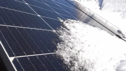 Snow Melting on PV Solar Panels Located on Private House Roof on Sunny Day Stock Footage 259183894