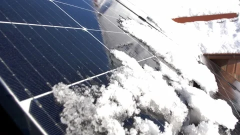 Snow Melting on PV Solar Panels Located on Private House Roof on Sunny Day Stock Footage 259184026