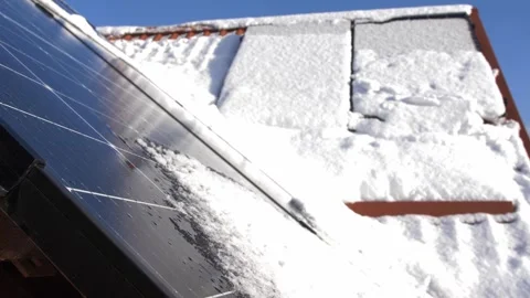 Snow Melting on PV Solar Panels Located on Private House Roof on Sunny Day Stock Footage 259184280