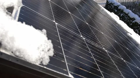 Snow Melting on PV Solar Panels Located on Private House Roof on Sunny Day Stock Footage 259184900