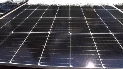 Snow Melting on PV Solar Panels Located on Private House Roof on Sunny Day Stock Footage 259186587